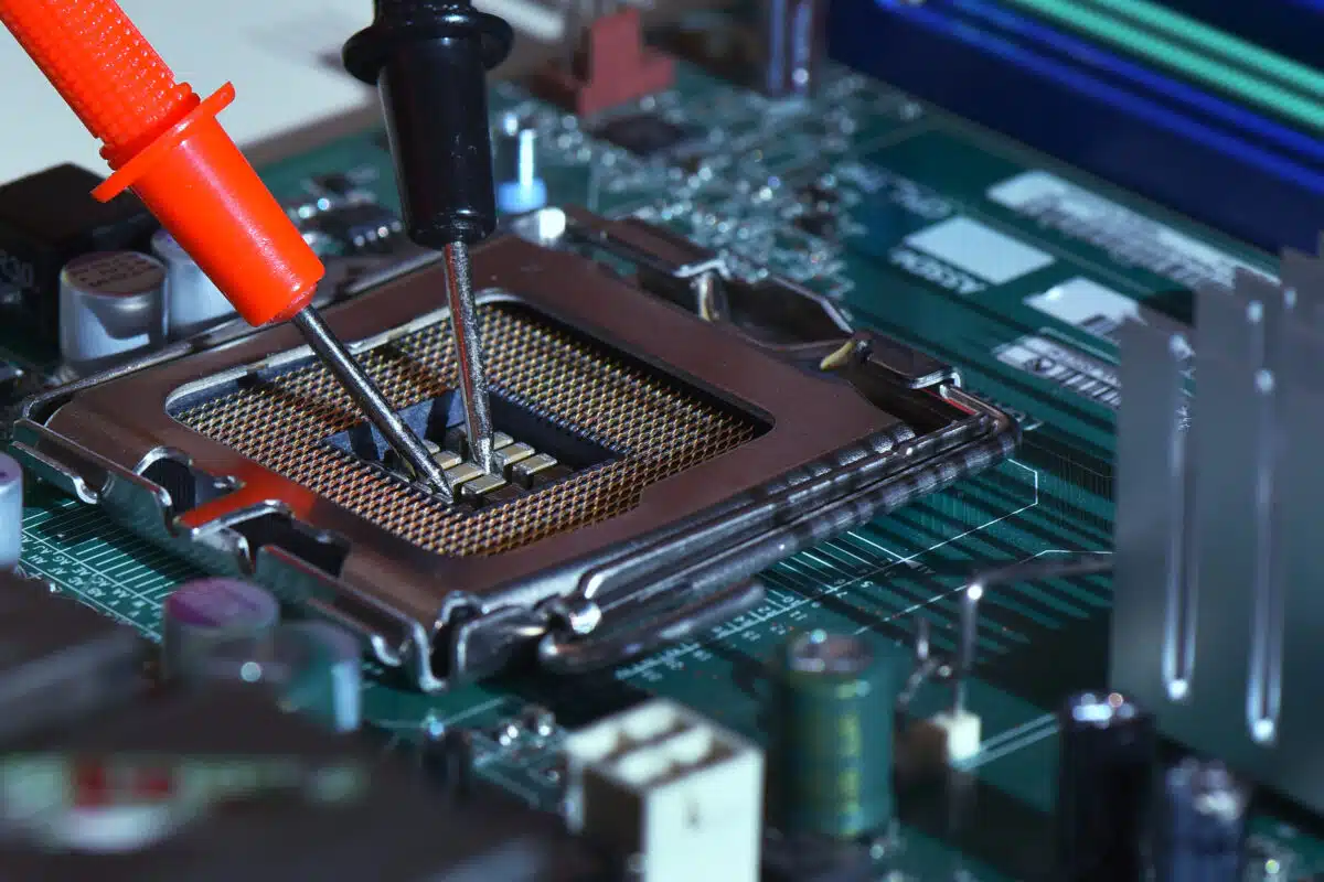 Close up needle tipped tip multimeter checking service repairing cpu computer. Repairing and service concept